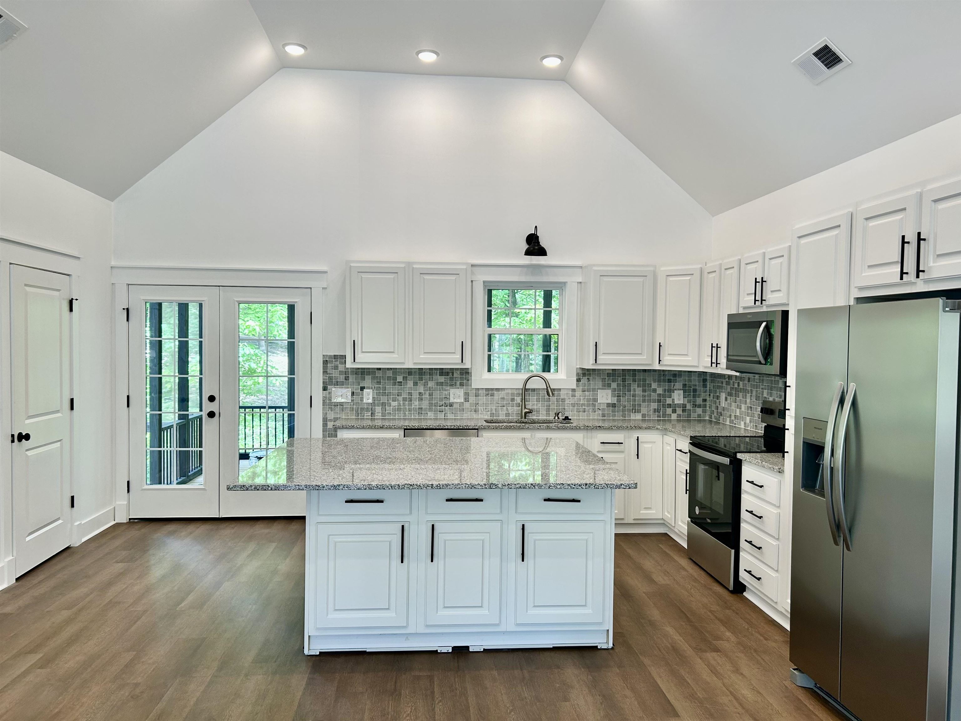 35 Grapevine Cove Counce, TN 38326 - Photo 6 of 25 a kitchen with stainless steel appliances granite countertop a stove and a refrigerator