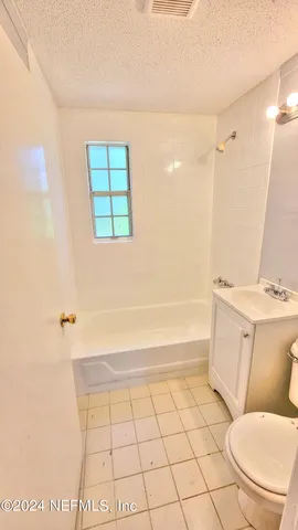 a bathroom with a toilet a sink and bathtub