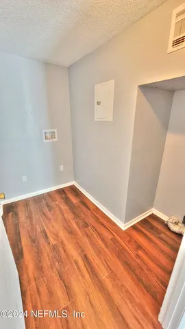 a view of a room with wooden floor