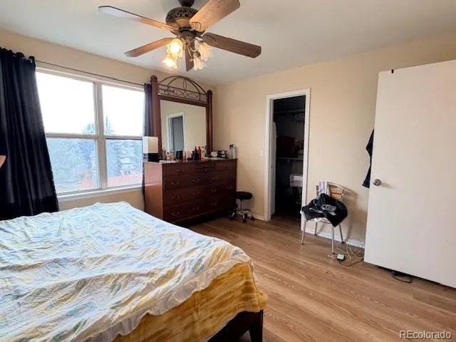 a bedroom with a bed dresser and a window