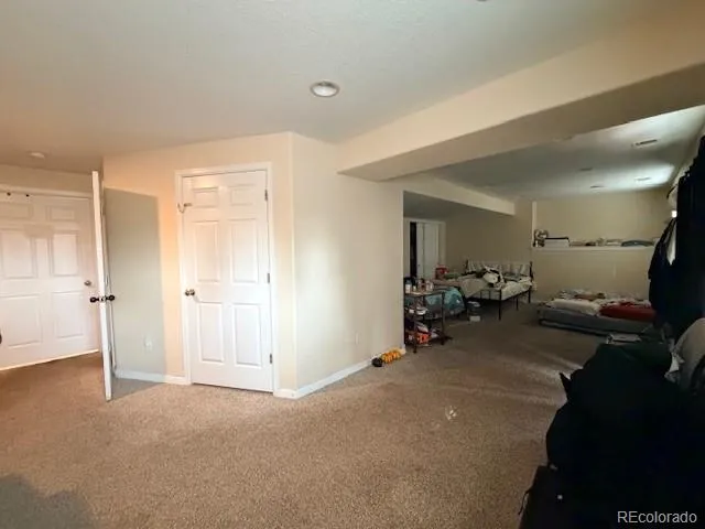 a living room with furniture gym equipment and a large mirror