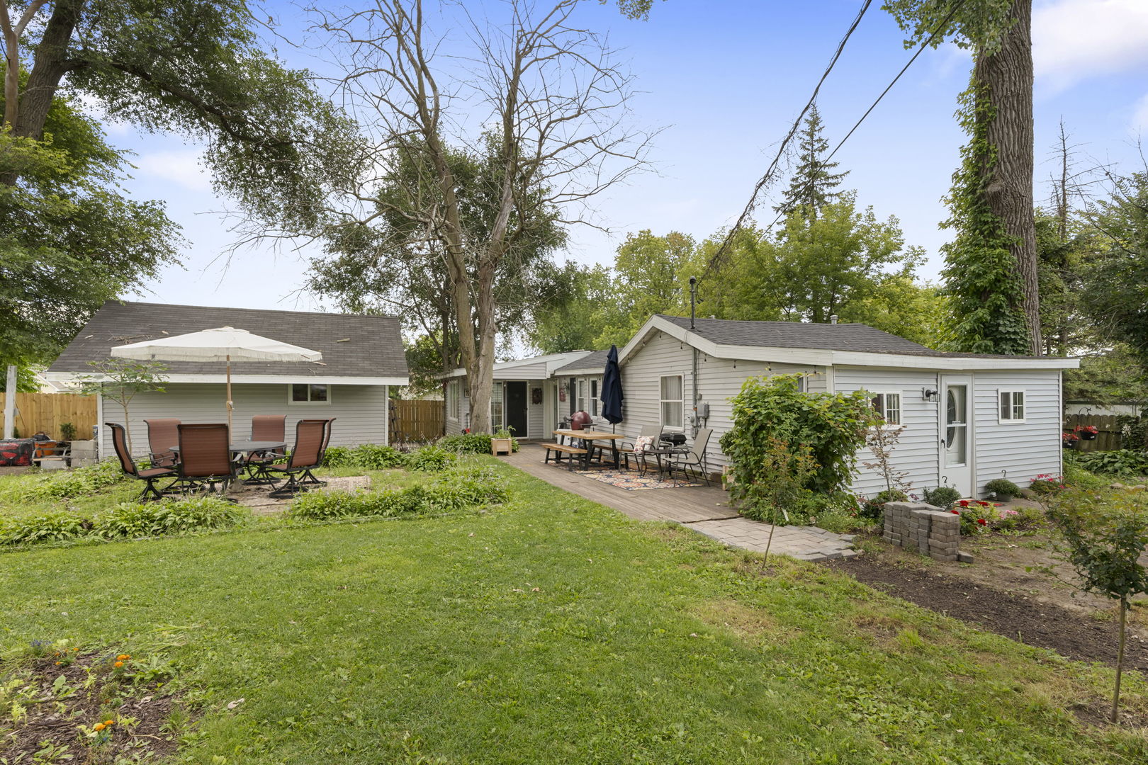 a view of a house with a yard and sitting area
