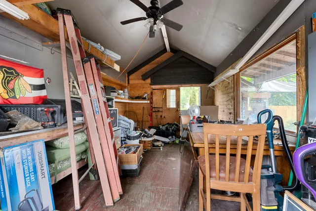 a view of a patio with table and chairs under an umbrella