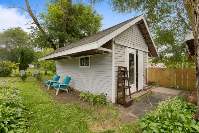a view of a house with backyard and sitting area