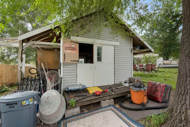 a backyard of a house with table and chairs
