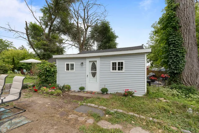 a backyard of a house with yard and outdoor seating