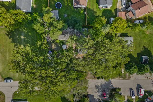 an aerial view of a house with yard