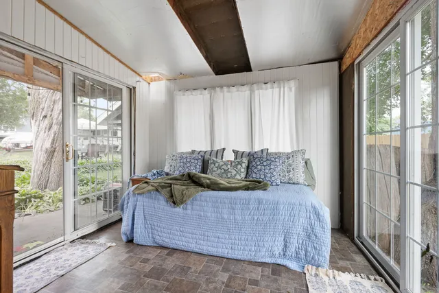 a bed sitting in a bedroom next to a window