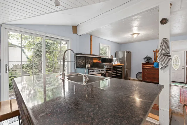 a kitchen with stainless steel appliances granite countertop a stove oven and a sink with granite countertops