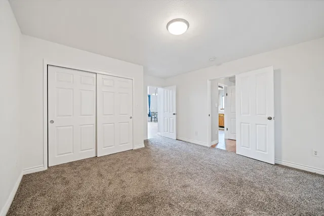 a view of an empty room and closet area