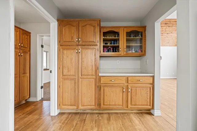 a kitchen with a refrigerator a sink dishwasher with a dining table and chairs