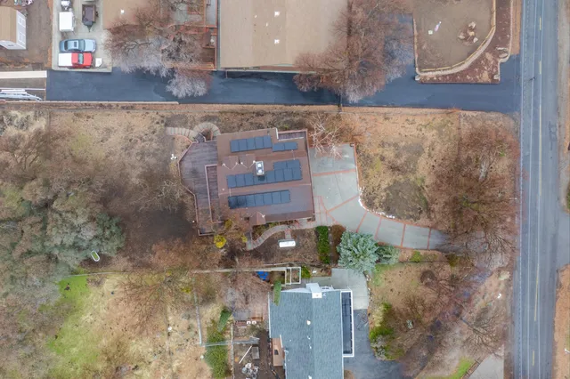 an aerial view of a house with a yard