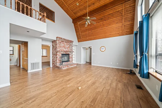a view of a livingroom with wooden floor and a staircase