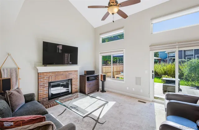 a living room with furniture a fireplace and a flat screen tv