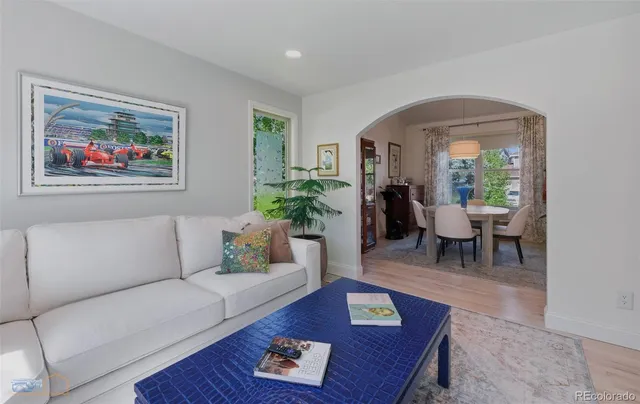 a living room with furniture and a potted plant