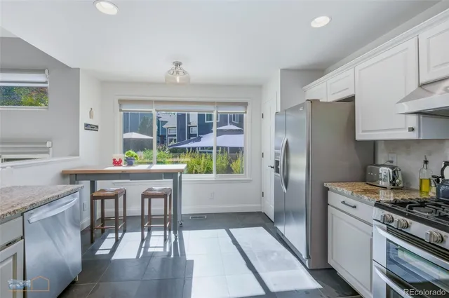 a kitchen with a table chairs stove and cabinets