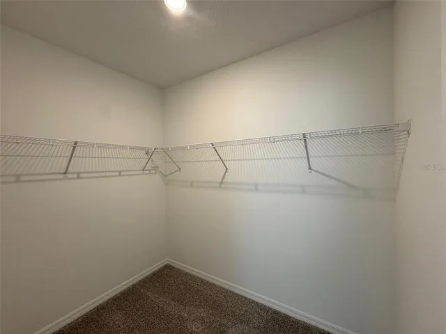 an empty room with windows and closet in it