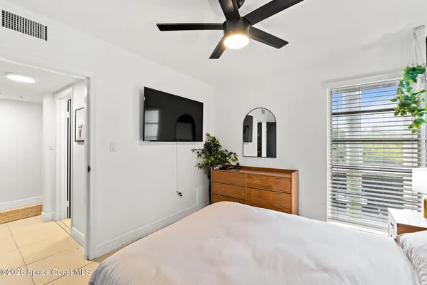 a bedroom with a bed and a flat screen tv