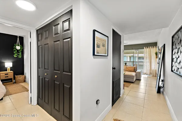 a view of a hallway with living room and furniture