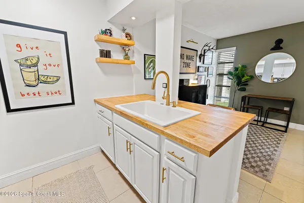 a room with kitchen island a table and chairs