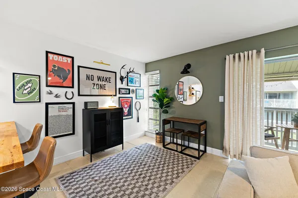 a living room with furniture a clock and a window