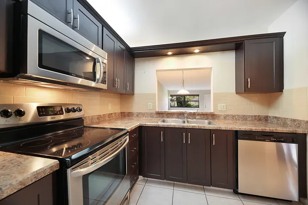 a kitchen with stainless steel appliances a sink stove and microwave