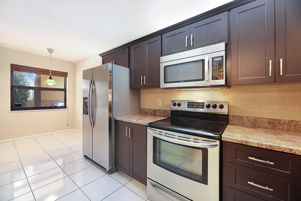 a kitchen with granite countertop cabinets and steel stainless steel appliances