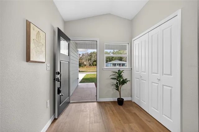 a view of an entryway with wooden floor