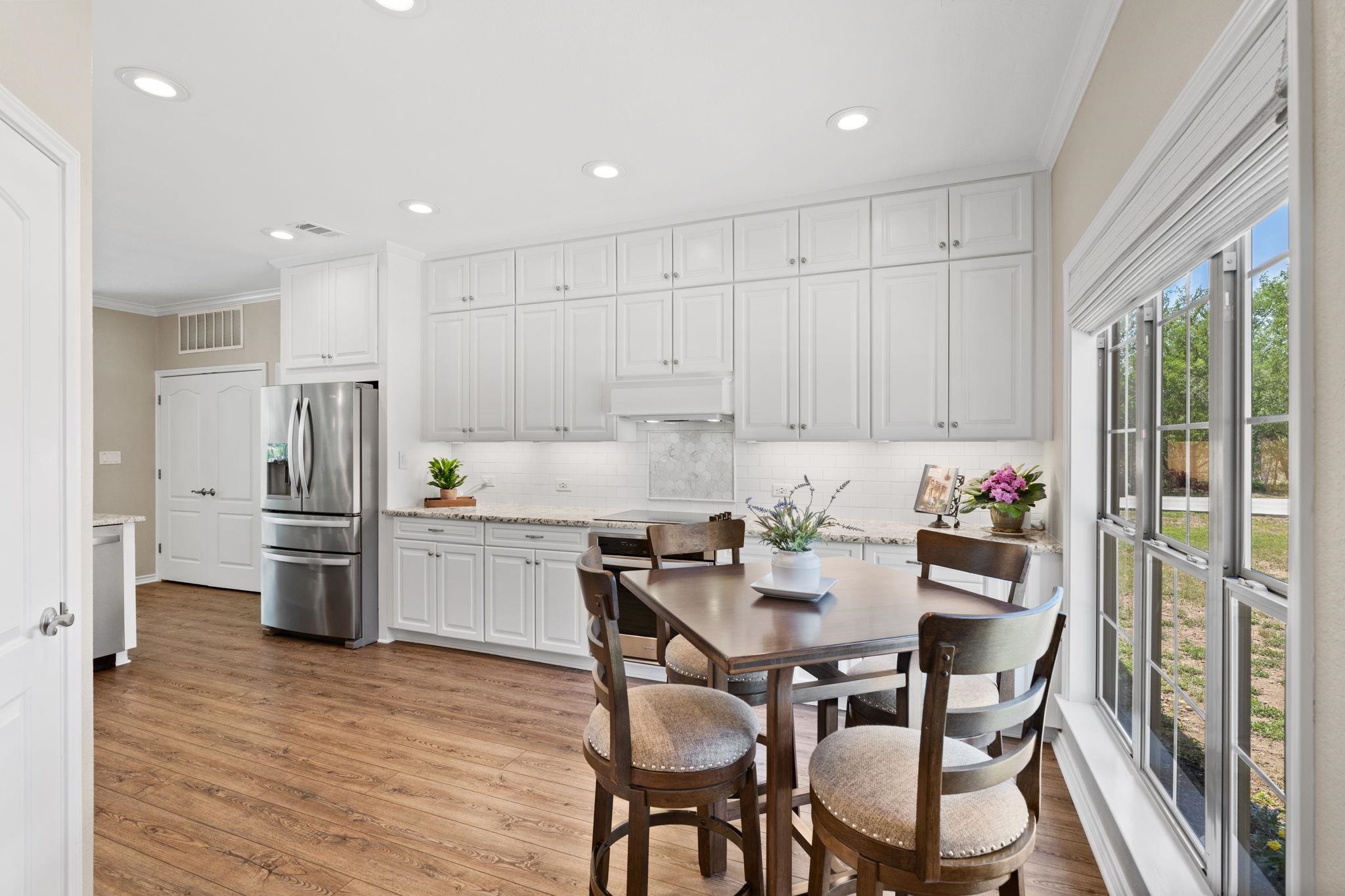 2409 Mormon Mill Road Marble Falls, TX 78654 - Photo 7 of 30 a kitchen with refrigerator and chairs