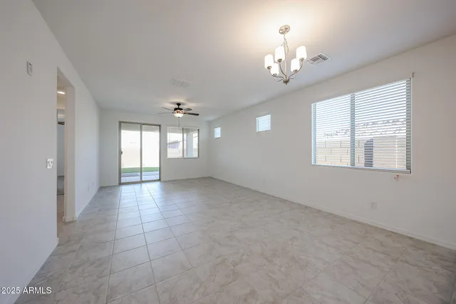 a view of an empty room with a chandelier