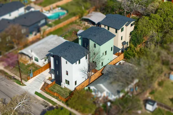 an aerial view of residential houses with outdoor space