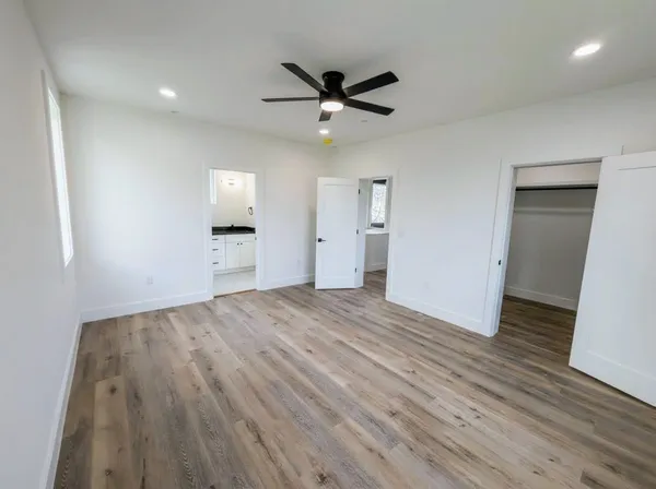 wooden floor in an empty room with a window