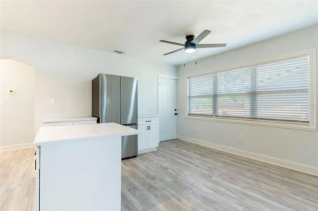 a kitchen with a refrigerator and a sink