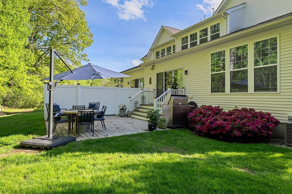 2 Hummingbird Way, Unit 1 Methuen, MA 01844 - Photo 33 of 42 a front view of a house with a garden and patio