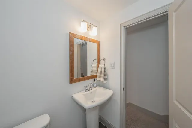 a room with a sink mirror and a couch
