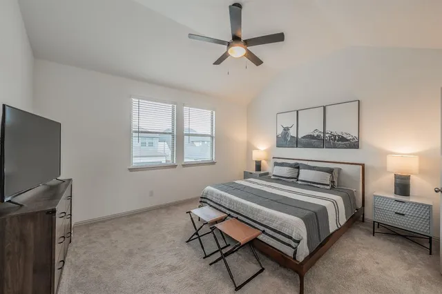a view of a room with a table and chairs