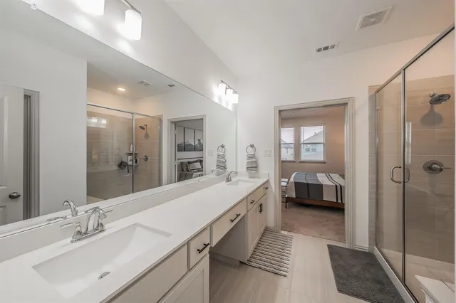 a bathroom with a double vanity sink mirror and double