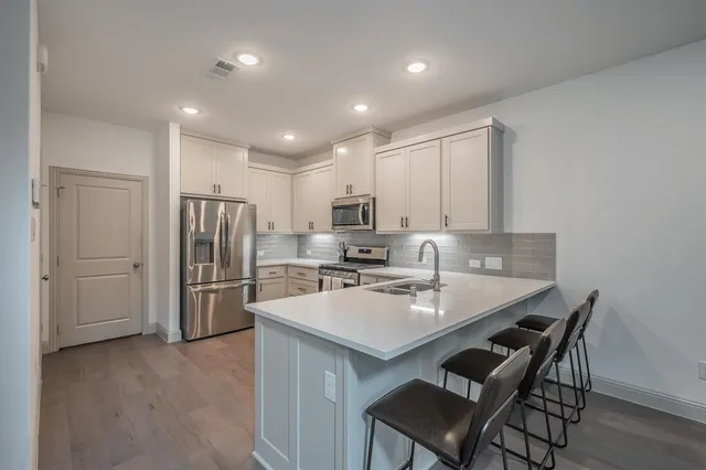 a kitchen with refrigerator and cabinets