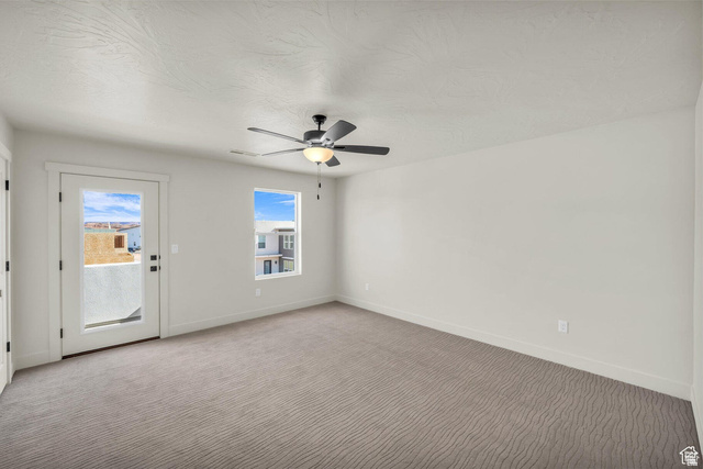 560 Aqua Cove St. George, UT 84790 - Photo 11 of 27 Empty room featuring ceiling fan and light colored carpet