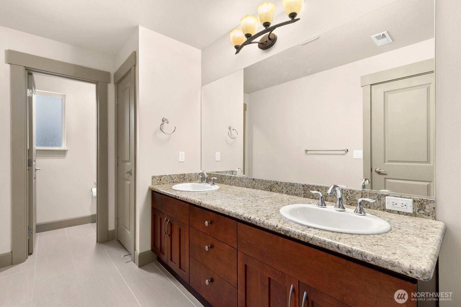 2115 201st Place Southeast, Unit H3 Bothell, WA 98012 - Photo 19 of 37 a bathroom with a granite countertop sink and a mirror
