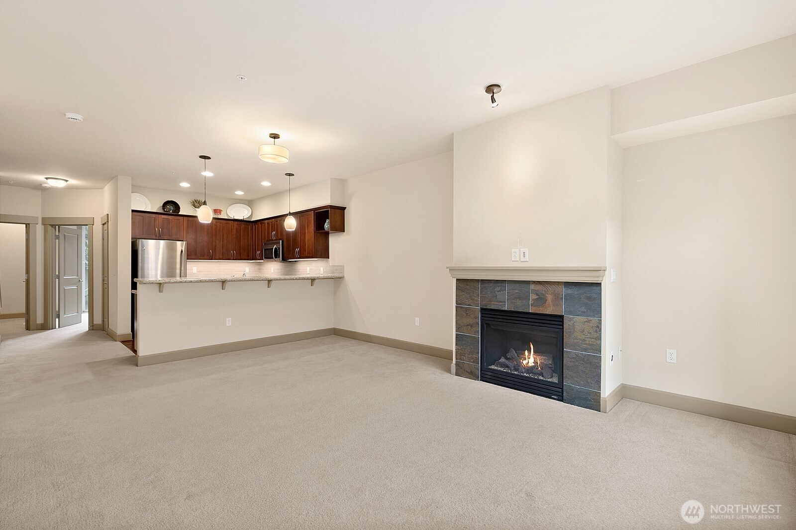 2115 201st Place Southeast, Unit H3 Bothell, WA 98012 - Photo 6 of 37 a view of a kitchen and a fireplace