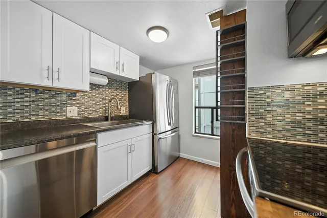 a kitchen with stainless steel appliances granite countertop a stove and a refrigerator