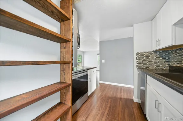 a view of a room with wooden floor and windows