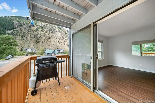 a view of a chairs and a table in the balcony