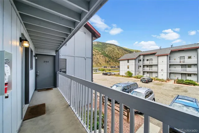 a view of a porch with a table and chairs