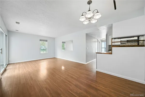a view of a room with wooden floor and windows