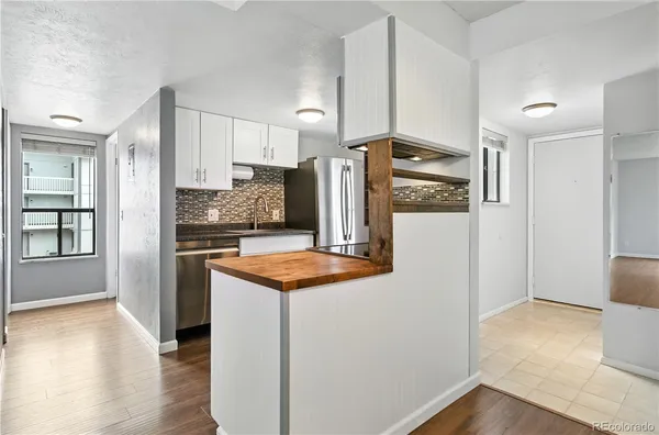 a kitchen with stainless steel appliances granite countertop a refrigerator and a stove