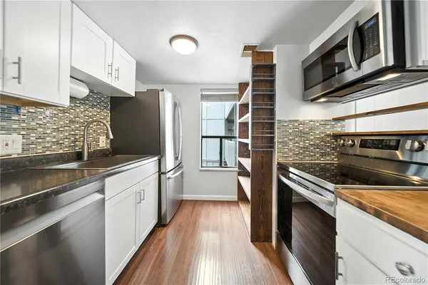 a kitchen with stainless steel appliances and granite countertop a stove top oven