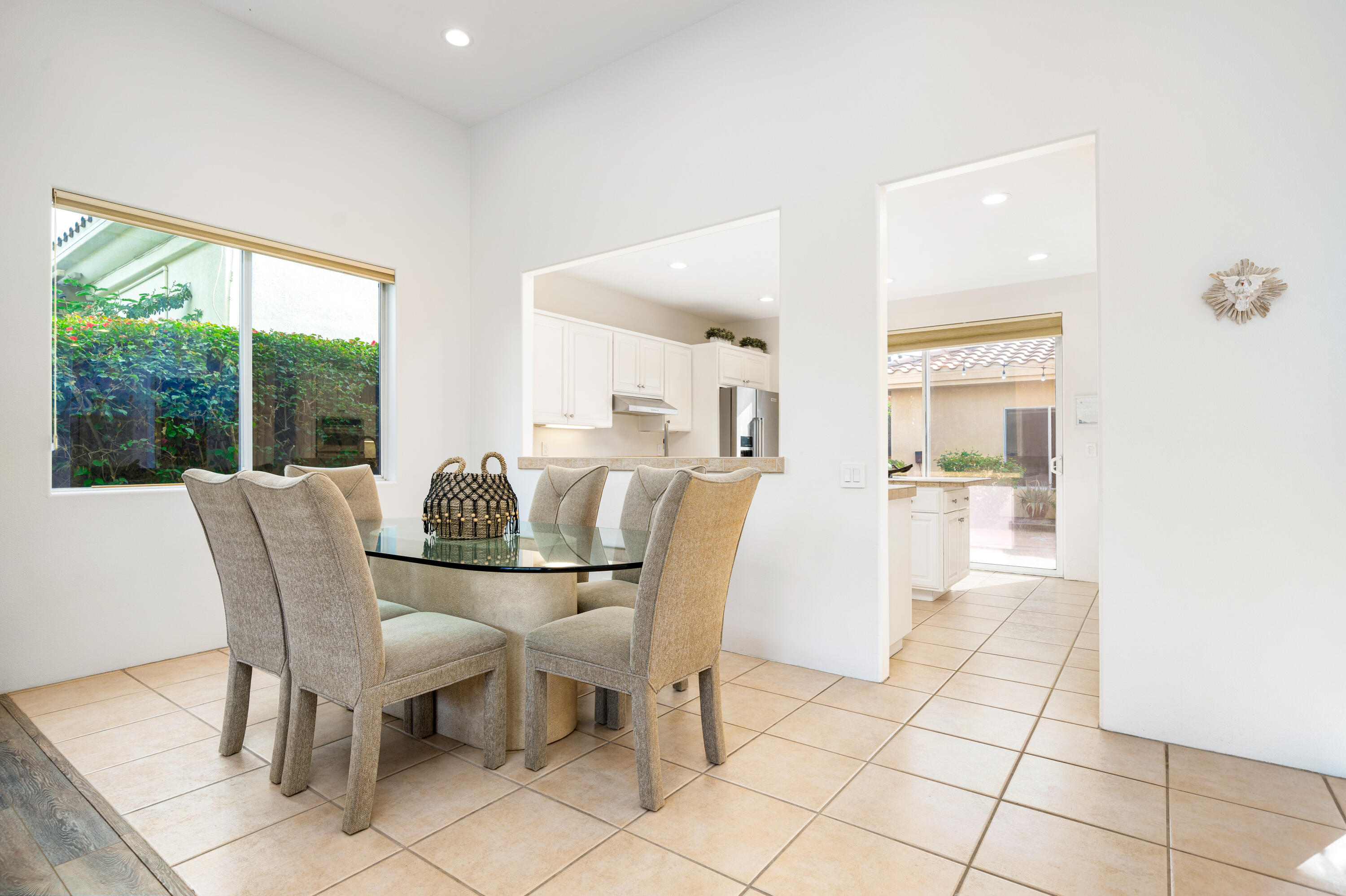 79060 River Rock Road La Quinta, CA 92253 - Photo 11 of 36 a dining room with furniture and large windows