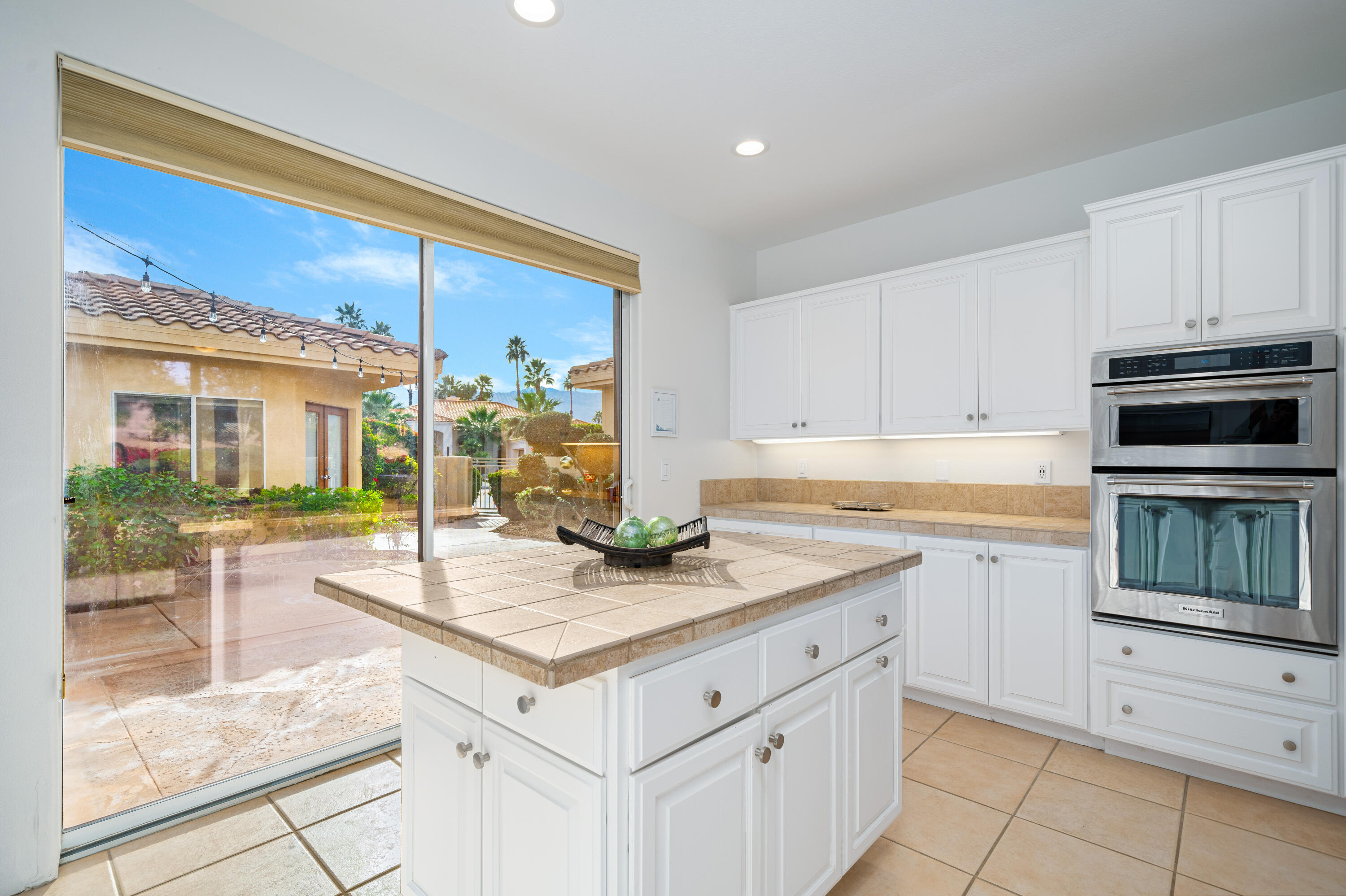 79060 River Rock Road La Quinta, CA 92253 - Photo 15 of 36 a kitchen with a stove a sink and a microwave
